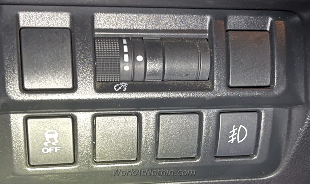 Fog light dash switch installed - close up.